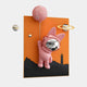 The Pink 3D Astronaut Bunny Balloon Lighthouse Wall Art by Giant Sculptures shows a pink astronaut with bunny ears floating in front of an orange background, holding a cratered pink balloon. Planets and a distant lighthouse complete this whimsical art piece for space enthusiasts.