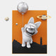 The Chrome 3D Astronaut Bunny Balloon Lighthouse Wall Art by Giant Sculptures features a whimsical bunny astronaut floating with a balloon, set against an orange sky with mountains and lighthouse for playful cosmic décor.