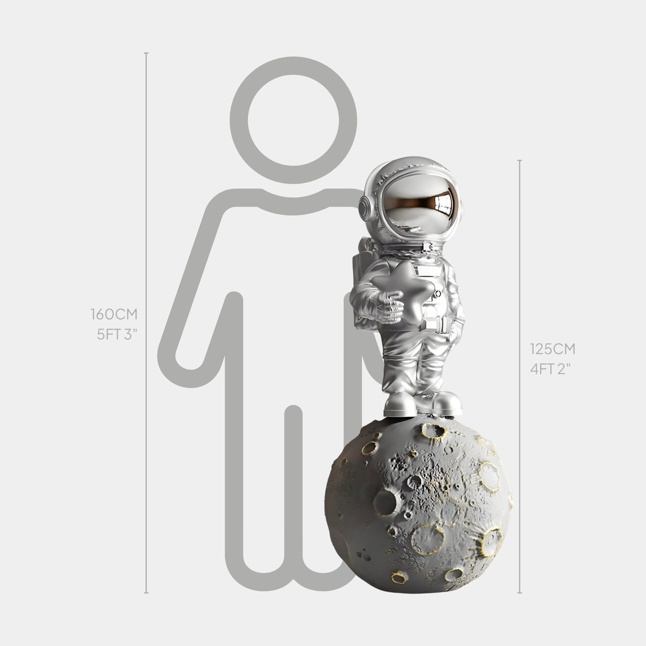 The Lunar Silver Astronaut Star On Moon Sculpture by Giant Sculptures, standing 125 cm tall, is showcased with a textured moon. A 160 cm gray human silhouette in the backdrop adds interplanetary flair and an artistic height contrast.