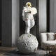 Giant Sculptures White Space Astronaut Glow Moonwalk Sculpture (126cm) features a white astronaut with a reflective gold visor on a moon-like base, cradling a glowing sphere. Its perfect for adding elegance to modern dark-walled rooms with light-colored sofas.