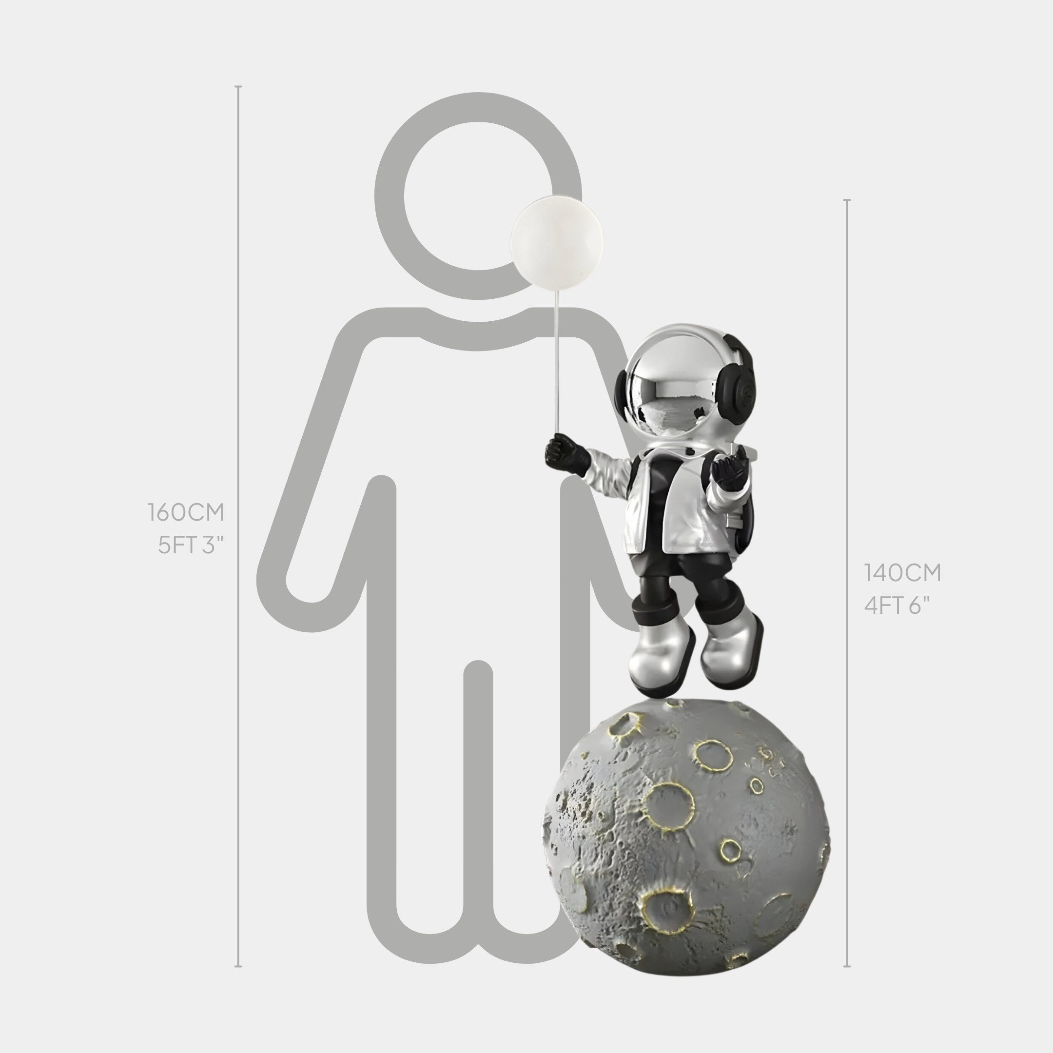 The Lunar Silver Astronaut Glow Balloon Moonwalk Sculpture by Giant Sculptures features a small astronaut with a white balloon on a moon-like sphere, subtly illuminated. The sculpture stands 140 cm (4 ft 6 in), shown alongside the height of an average person at 160 cm (5 ft 3 in).