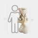 The Warm Beige Cloudsit Glider Bear Sculpture by Giant Sculptures stands 150 cm tall, sitting on a yellow star above white clouds. Shown next to a 160 cm human outline for scale.