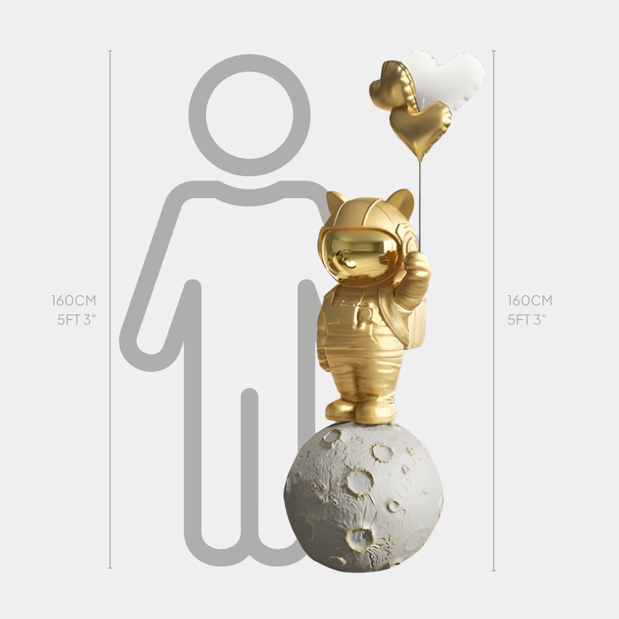 The Gilded Gold Astronaut Kitty Heart Balloons Sculpture by Giant Sculptures stands 160 cm tall on a cratered moon model, holding a heart-shaped balloon with a grey human outline behind to enhance its size—a captivating décor piece.