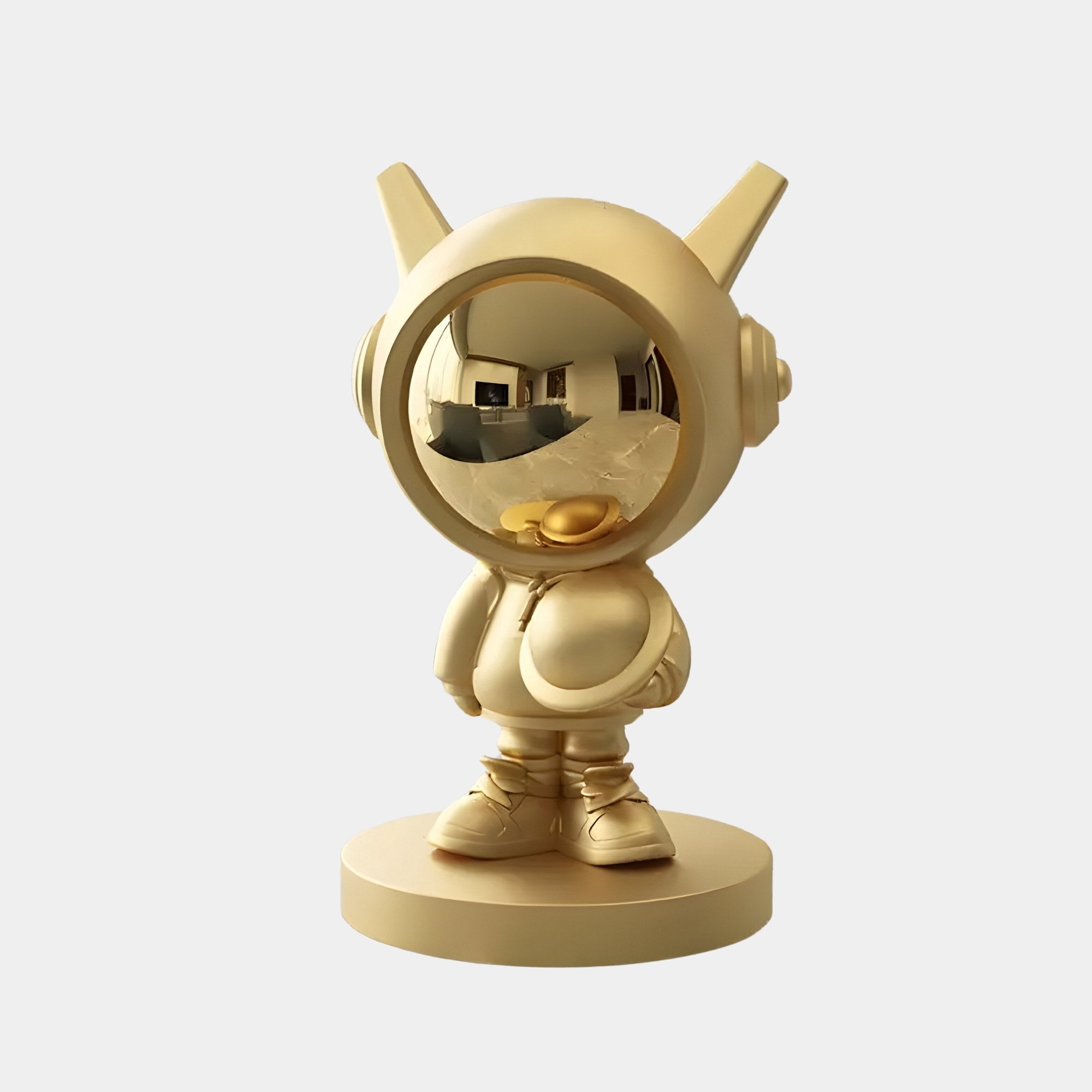 Introducing the 30cm Celestial Gold Astronaut DJ Figure from Giant Sculptures, a golden figurine with a reflective helmet and duckbill-shaped mouthpiece. This cosmic-themed figure stands poised on a round base against a plain white background.