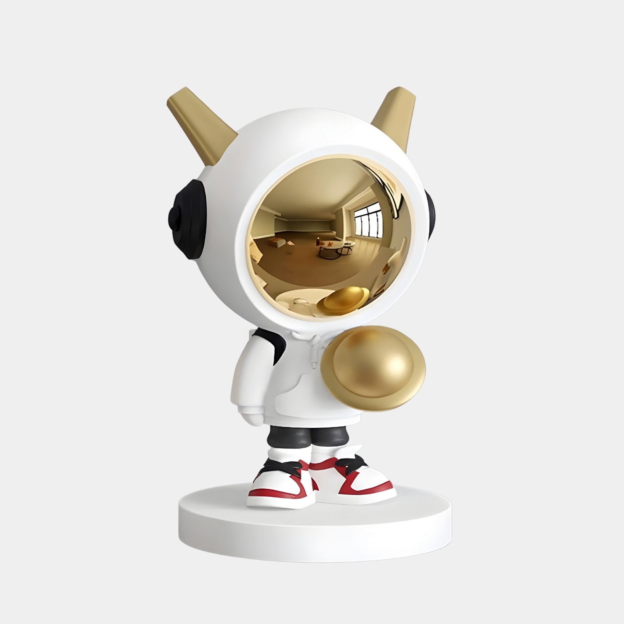 The Nova White Astronaut DJ Figure by Giant Sculptures features a character with a gold reflective face, white helmet with gold horns, white body highlighted by black accents and red-striped shoes, all standing on a circular white base.