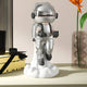 The Giant Sculptures Lunar Silver Astronaut Lift-Off Mini Figure (30cm) features a reflective helmet and gloves, standing on a cloud-like base—an eye-catching modern sculpture for your tabletop or display shelf.