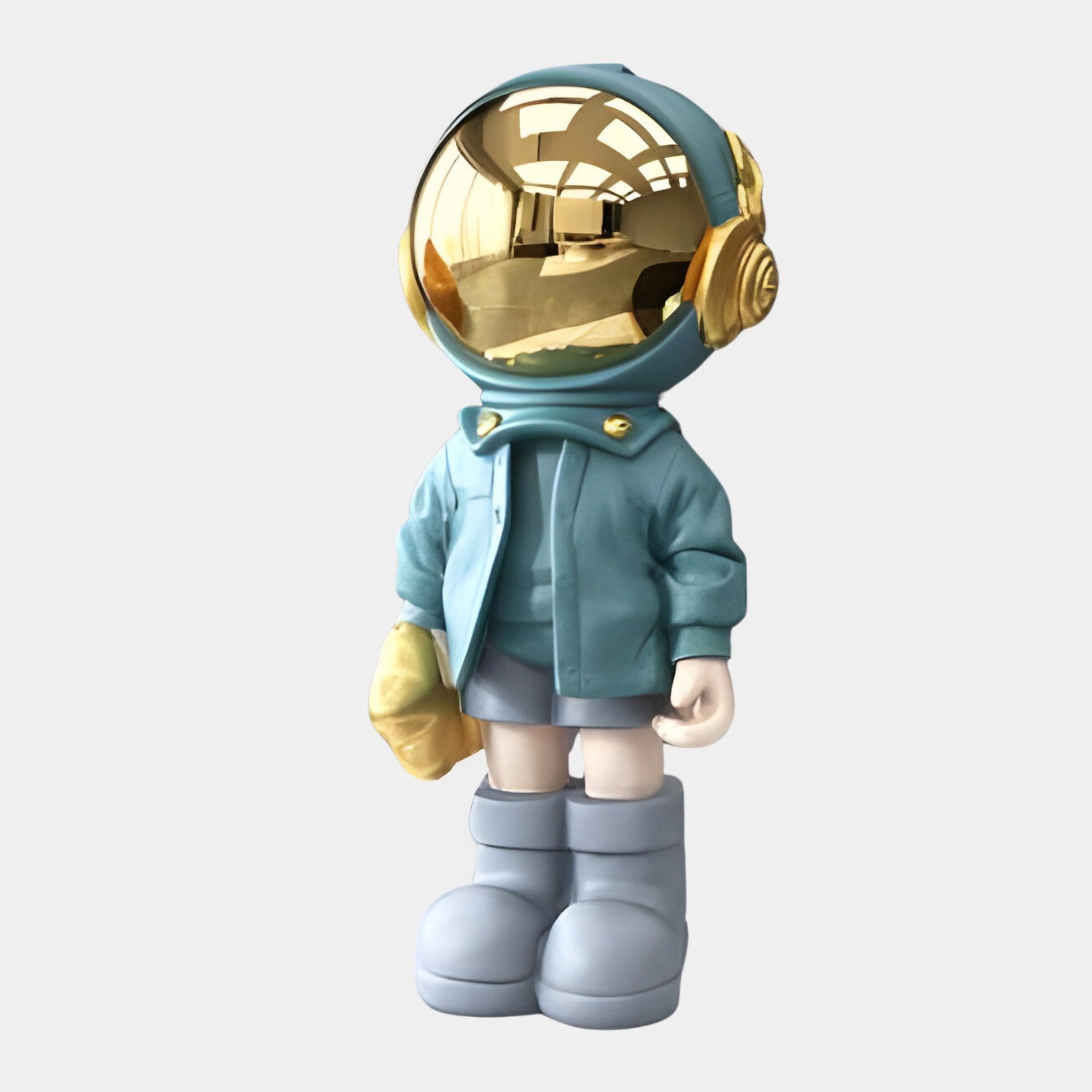 The Galactic Blue Astronaut Beats Figure by Giant Sculptures is a 36cm toy with a helmet featuring a reflective gold visor, blue jacket, gray shorts, and large gray boots. It holds a gold object and showcases sleek cosmic flair in its minimalistic design.