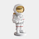 The Nova White Astronaut Star Figure by Giant Sculptures is a whimsical 37cm space-themed décor piece, with a glossy gold visor and star in hand. Dressed in a white spacesuit with red accents, it stands on a round base against a gray backdrop.