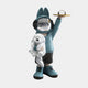 The Blue Astronaut Bunny Pup Butler Figure by Giant Sculptures is a whimsical 44cm piece featuring a mirrored helmet face, teal hoodie, black shorts, holding a white plush dog and offering a small clock on a gold plate—ideal for cosmic home decor lovers.