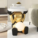The Celestial Gold Astronaut Glow Side Table Figure (50cm) by Giant Sculptures features a gold astronaut holding a tabletop and glowing orb, adding ambient light and modern decor beside your beige sofa.