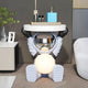 The Cosmic Sky Astronaut Glow Side Table Figure (50cm) by Giant Sculptures features a small astronaut holding a round tray for bottles and décor, with a glowing sphere in its lap for ambient light—perfect functional décor for modern living rooms.