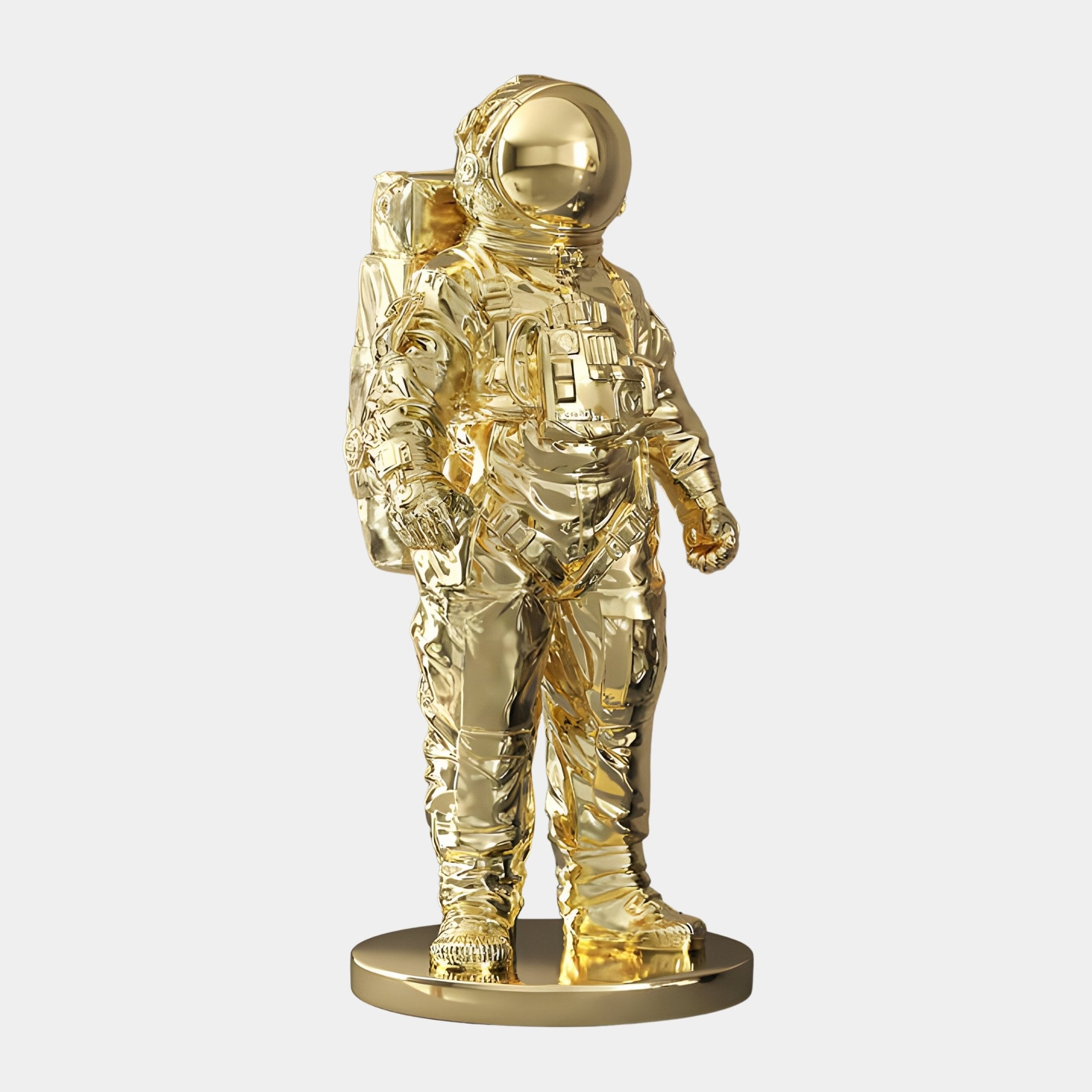 The Gilded Gold Space Astronaut Standing Sculpture by Giant Sculptures, measuring 58cm, captivates with its reflective finish and intricate spacesuit details like the helmet and backpack, all set on a circular base.