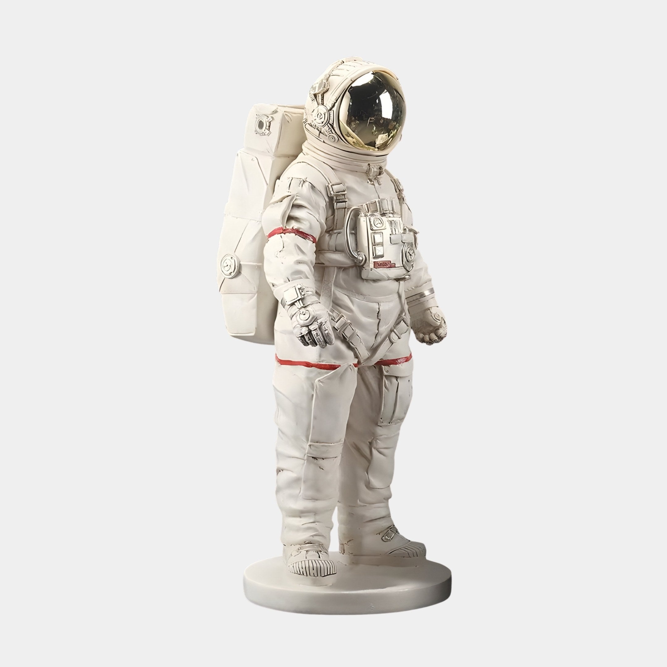 The Cloud White Space Astronaut Standing Sculpture by Giant Sculptures is a 58cm lifelike figure featuring a detailed suit with a reflective gold visor, backpack, equipment, and modern red detailing on a sleek circular base—ideal for space-themed décor.