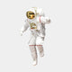 An astronaut in a white spacesuit with a gold visor floats effortlessly, resembling the White 3D Cosmic Lift Astronaut Wall Art by Giant Sculptures. The suits red accents and attachments evoke space exploration, capturing the essence of cosmic adventure.