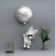 The Giant Sculptures Chrome Astronaut Bunny Balloon 3D Wall Art (58cm) features a cartoon bunny in a spacesuit with a moon balloon—an eye-catching piece for space-themed décor.