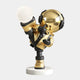 The Celestial Gold Astronaut Glow Kick Sculpture by Giant Sculptures features a shiny helmet, black gloves, and boots. Standing on a round base at 70cm, the piece showcases a high kick and includes adjustable lighting for enhanced reflections.