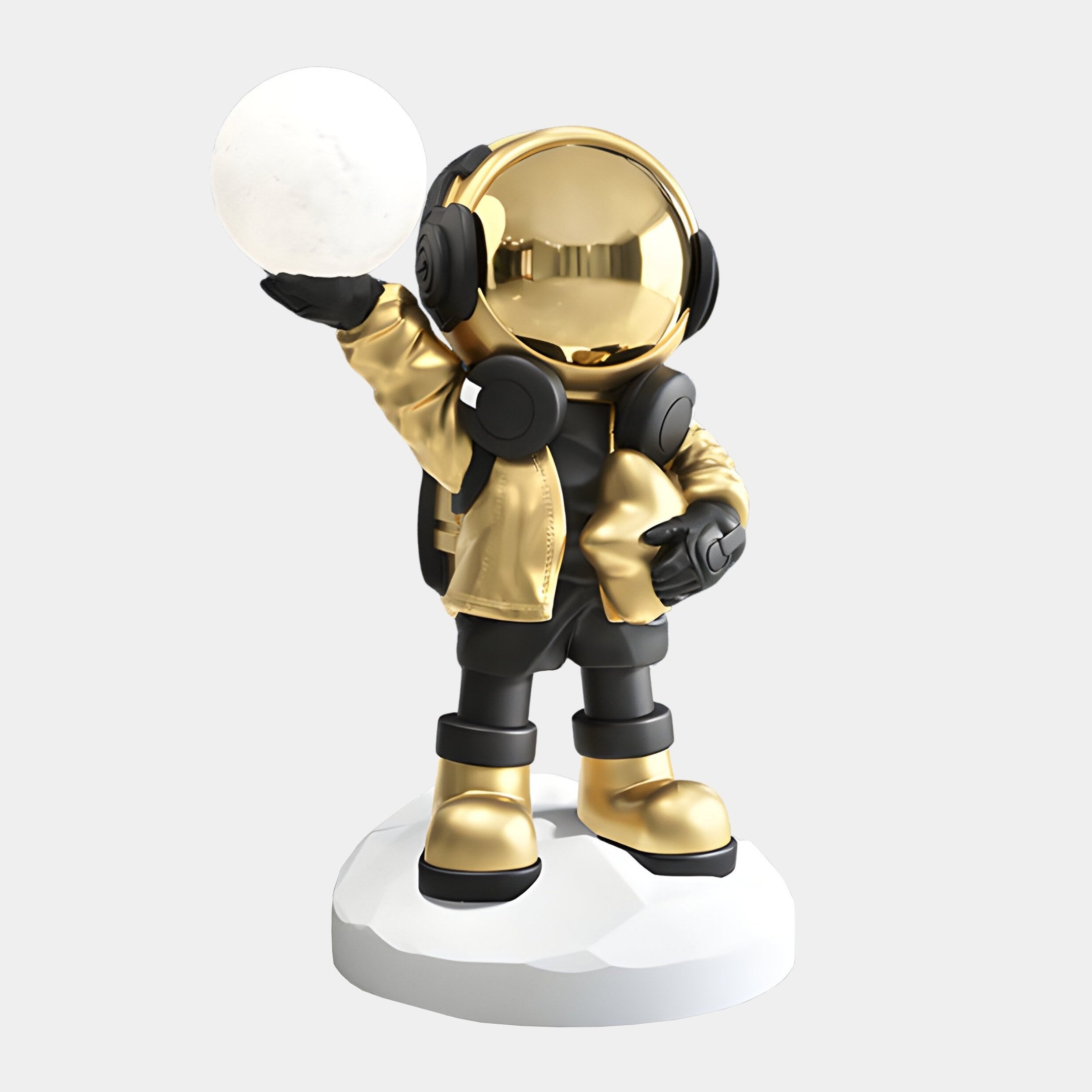 The Celestial Gold Astronaut Beats Glow Orb Sculpture by Giant Sculptures is a 75cm stylized figure on a white base, featuring a reflective gold helmet and jacket, black boots and gloves, and holding a glowing orb, embodying an astronauts cosmic journey.