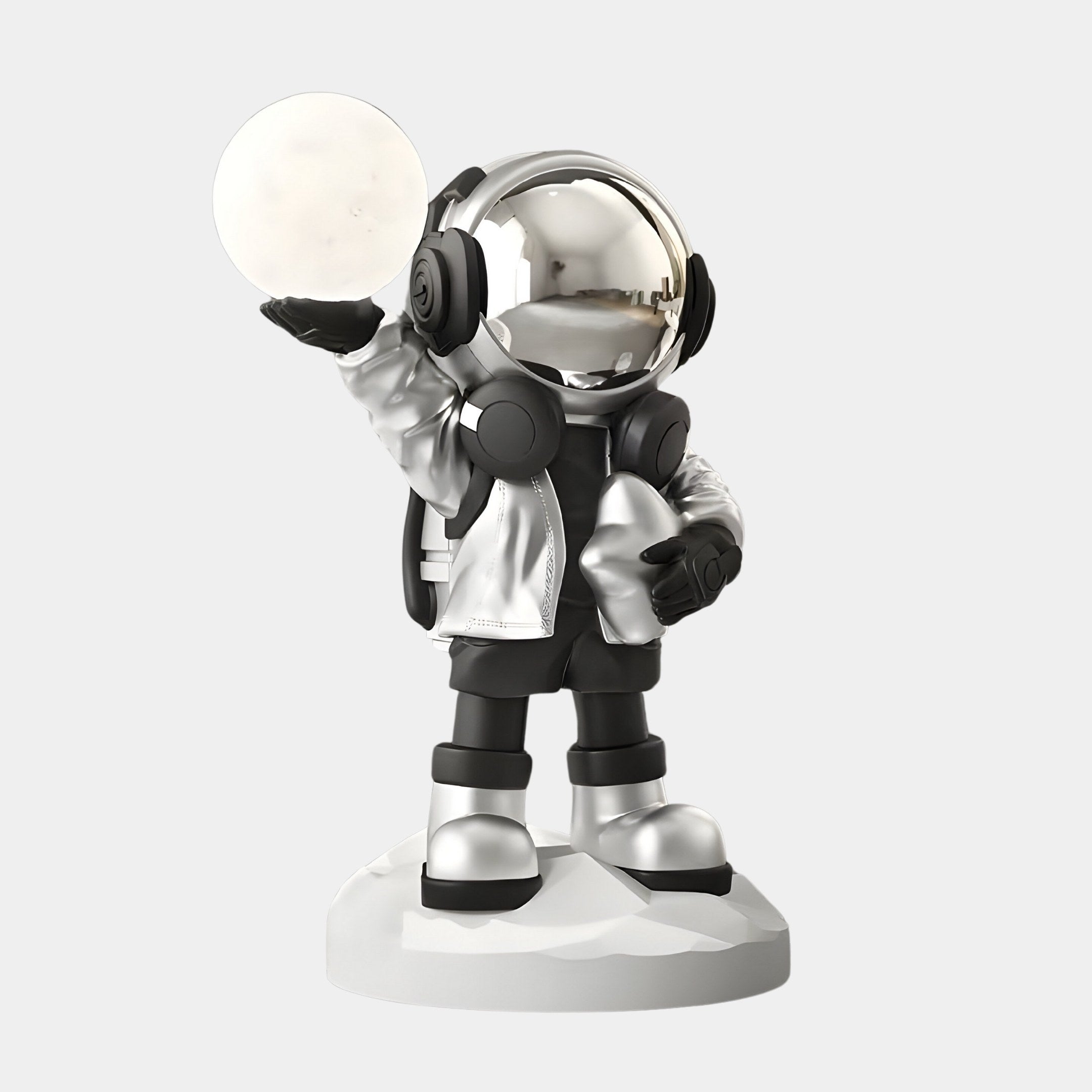 The Lunar Silver Astronaut Beats Glow Orb Sculpture by Giant Sculptures is a 75cm metallic figure on a round base, showcasing a cosmic vibe with its shiny, space-themed design that stands out against a white backdrop for a futuristic look.