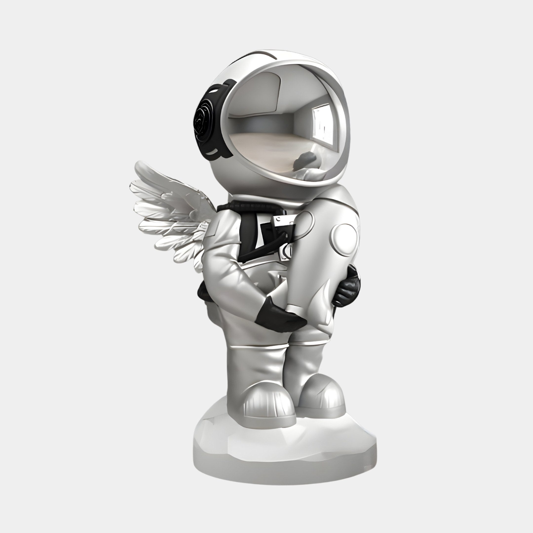 The Lunar Silver Astronaut Angel Rocket Sculpture (75cm) by Giant Sculptures features a whimsical winged figure with a shiny helmet and key, standing on a round base, making it a cosmic highlight for any space-themed collection.