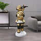 The Celestial Gold Astronaut Duo Server Sculpture by Giant Sculptures (78cm) features two stacked figures holding trays, creating a functional statement piece perfect for modern living rooms with plants and stylish décor.