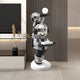 The Giant Sculptures Lunar Silver Astronaut Duo Server Sculpture (78cm) features two astronauts—one standing with a white orb, the other forming a sleek tray—perfect for modern, minimal spaces.