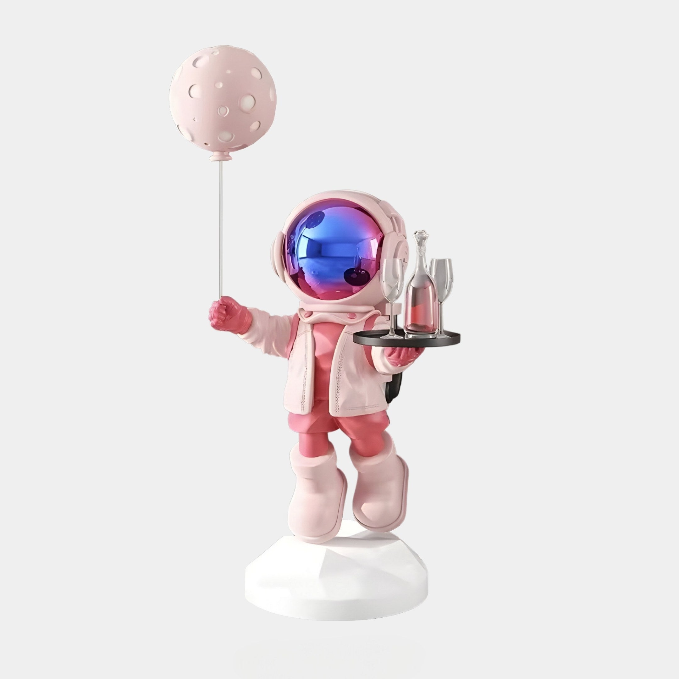 The Stellar Pink Astronaut Butler Balloon Sculpture by Giant Sculptures stands on a white base, showcasing celestial charm with its pink astronaut design, glossy helmet visor, and pink balloon. It holds a tray with two champagne flutes and a bottle. Dimensions: 80cm.