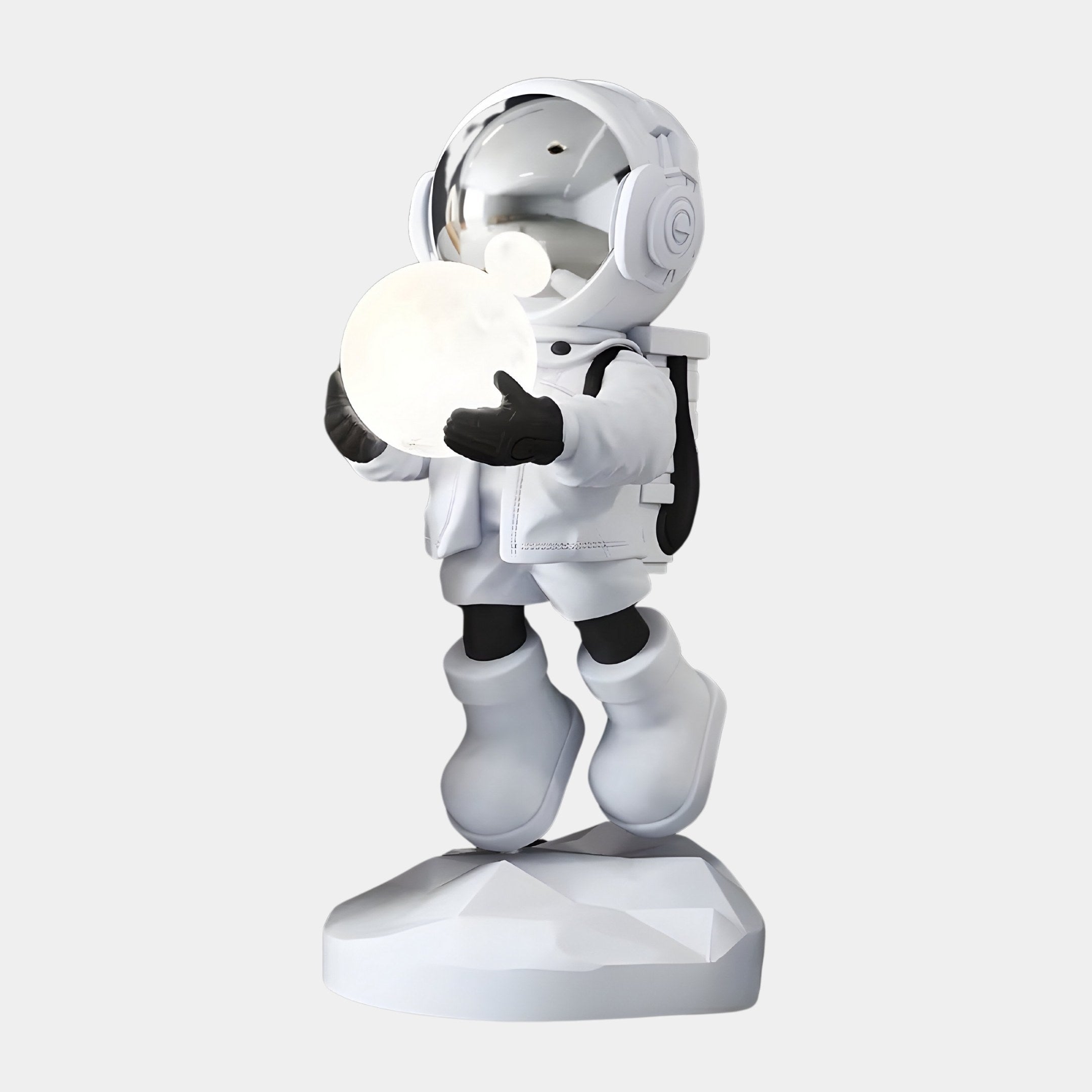 The Nova White Astronaut Glow Hover Sculpture by Giant Sculptures is a 80cm figure in a white spacesuit, standing on a geometric base and holding a glowing sphere. It doubles as a USB Charging Lamp, adding playful, futuristic décor to any setting.