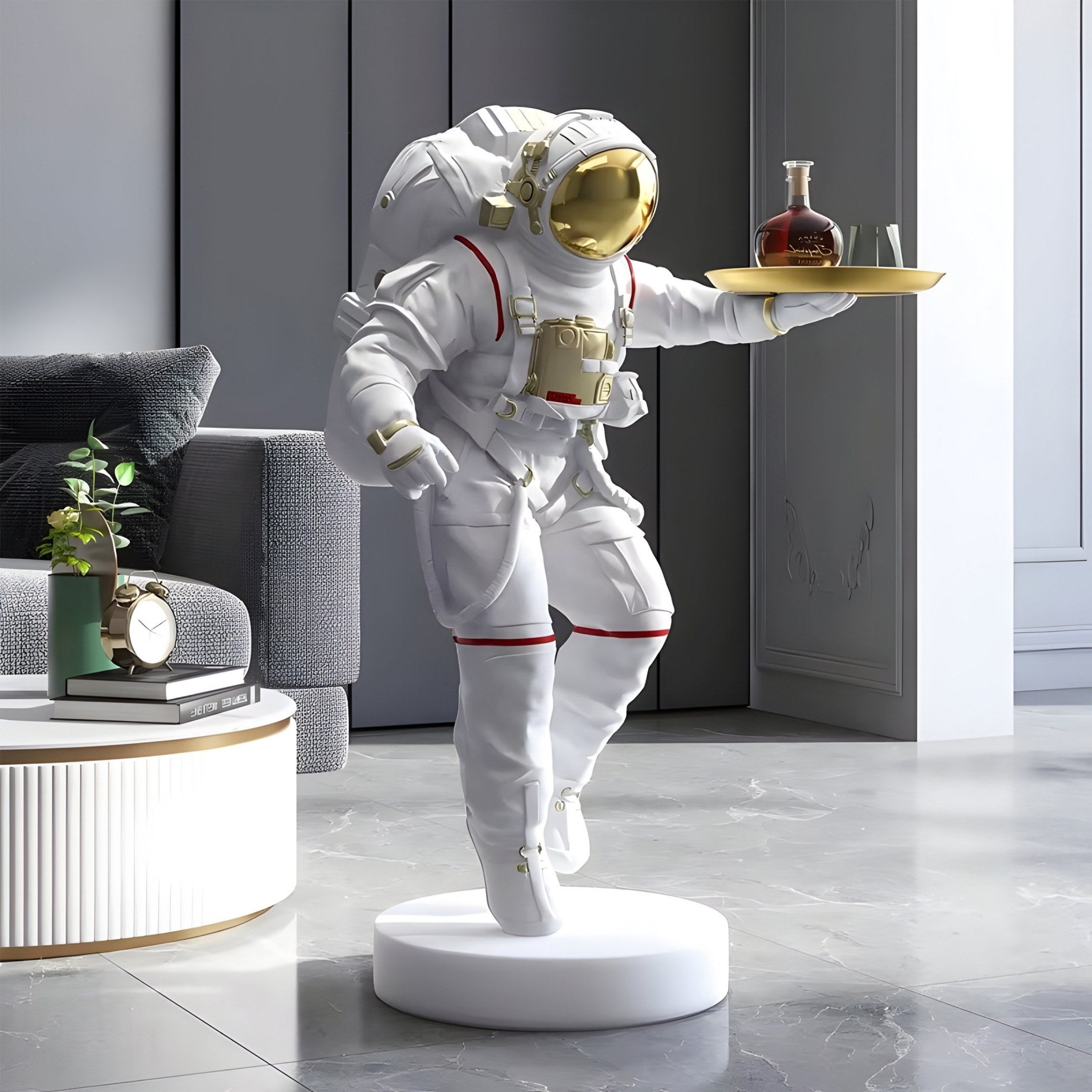 The Giant Sculptures White Space Astronaut Explorer Serve Sculpture - 85cm, depicting an astronaut holding a tray with a bottle and glass on a circular base, adds a cosmic touch beside a modern couch and small table with a clock and potted plant in the sleek minimalist living room.