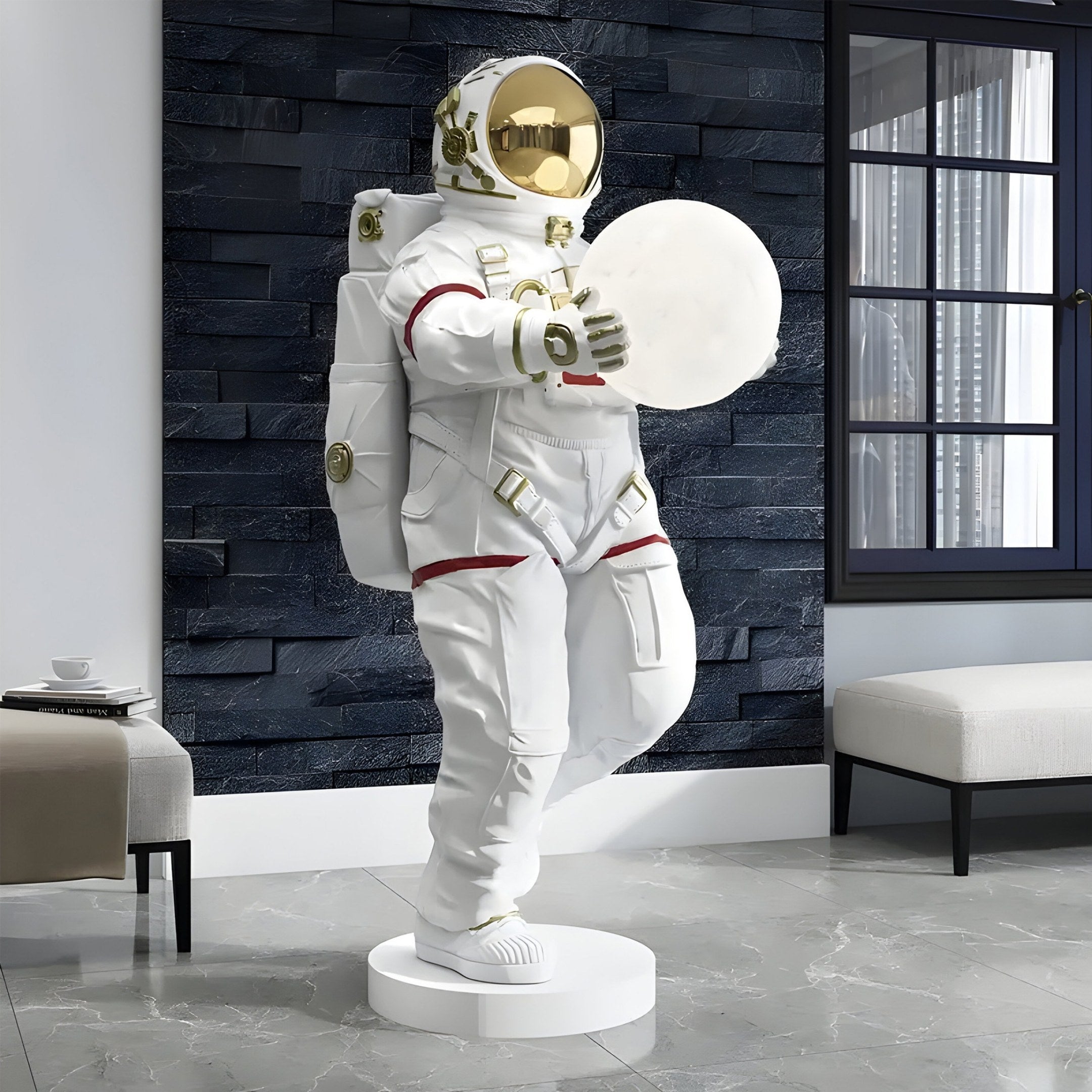 The White Space Astronaut Glow Orb Sculpture - 90cm by Giant Sculptures is showcased in a modern room with a black textured wall and large window. Its reflective visor adds intrigue, while minimalistic furniture with a white cup on a low table enhances the cosmic home decor vibes.