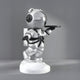 The Astral Silver Astronaut Bear Butler Sculpture by Giant Sculptures stands 90cm tall, featuring a stylized astronaut with a large helmet, holding a round tray on a white base. The spacesuit shines in astral silver with black details against a gray background.