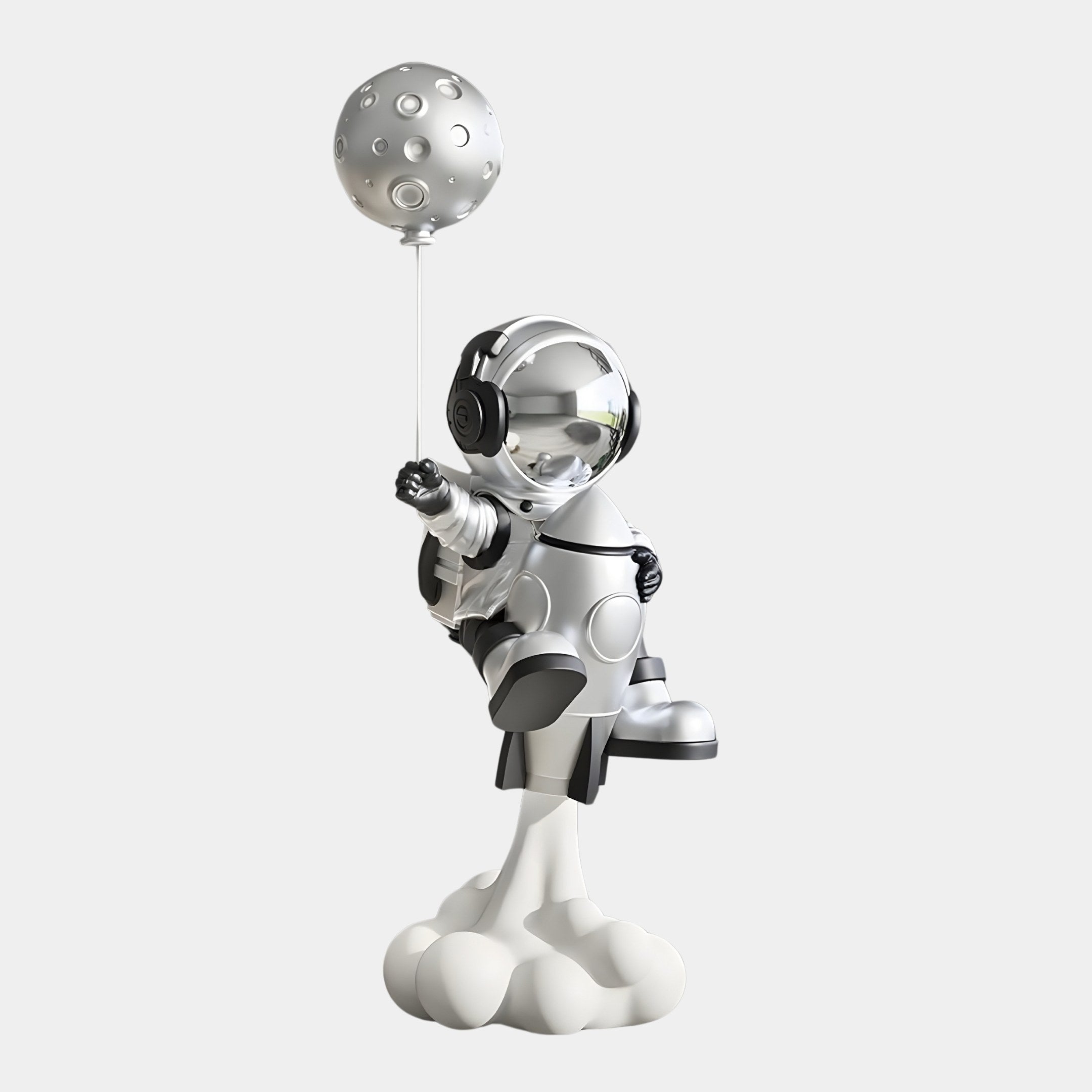 A Lunar Silver Astronaut from Giant Sculptures, 95cm tall, stands on a cloud holding a moon-textured balloon. This playful and futuristic Rocket Lift-Off Balloon Sculpture features a space-themed suit with headphones and antennas against a light background.