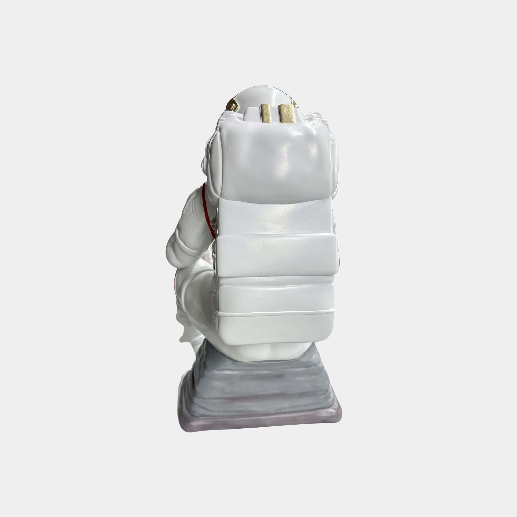 The Nova White Astronaut Thinker Figure by Giant Sculptures (43cm) features a resin astronaut in a white spacesuit, kneeling with a large backpack, viewed from behind—a bold cosmic sculpture for space lovers.