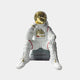 The Giant Sculptures Nova White Astronaut Thinker Figure (43cm) features a gold helmet and red accents, seated on a gray block with a thoughtful pose. Perfect for cosmic home decor against a plain light gray background.