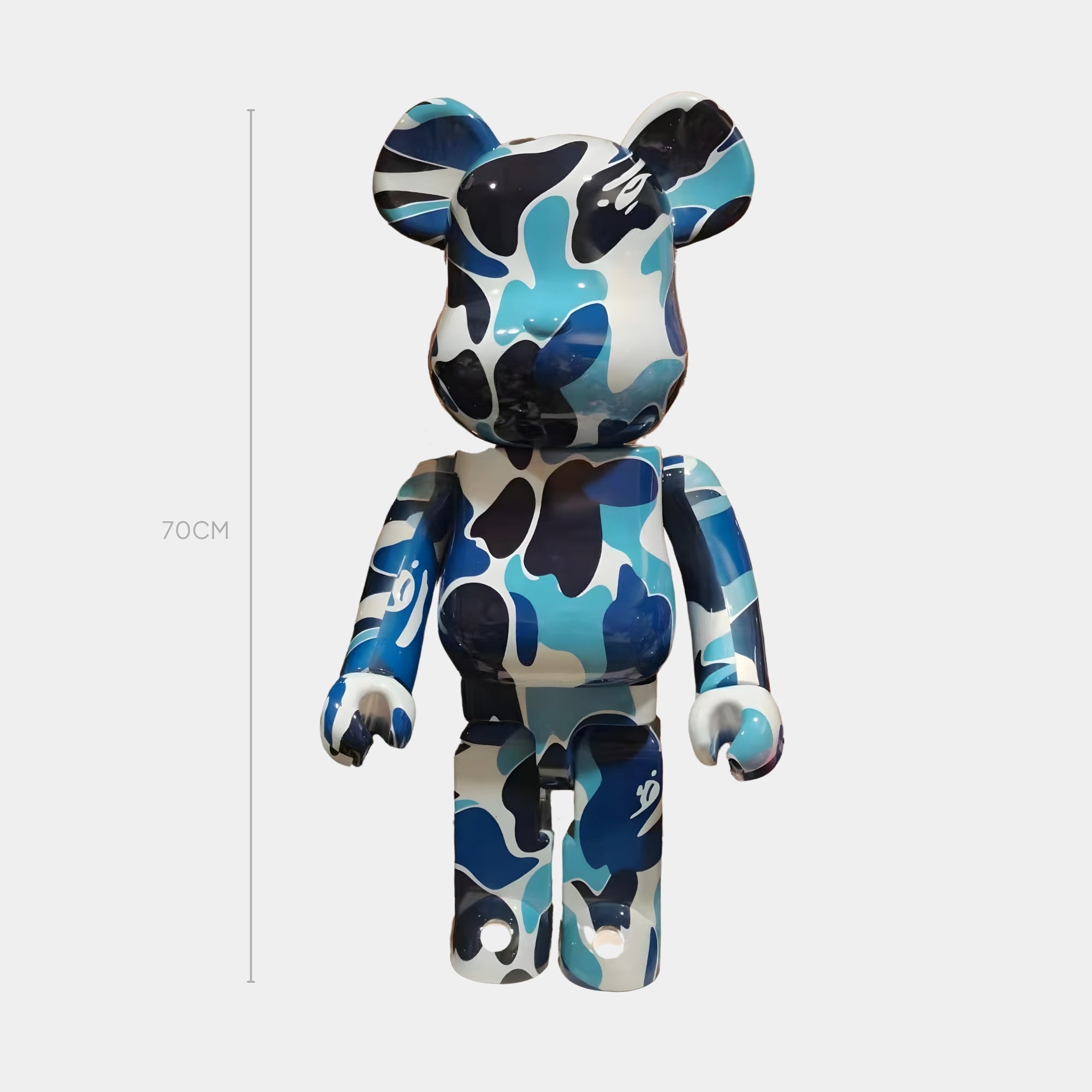 The Giant Sculptures Azure Drift Bear Sculpture - 70cm features a blue, black, and white camo pattern, stands upright against a plain white background, and includes a measurement line showing its height. Limited-run production.