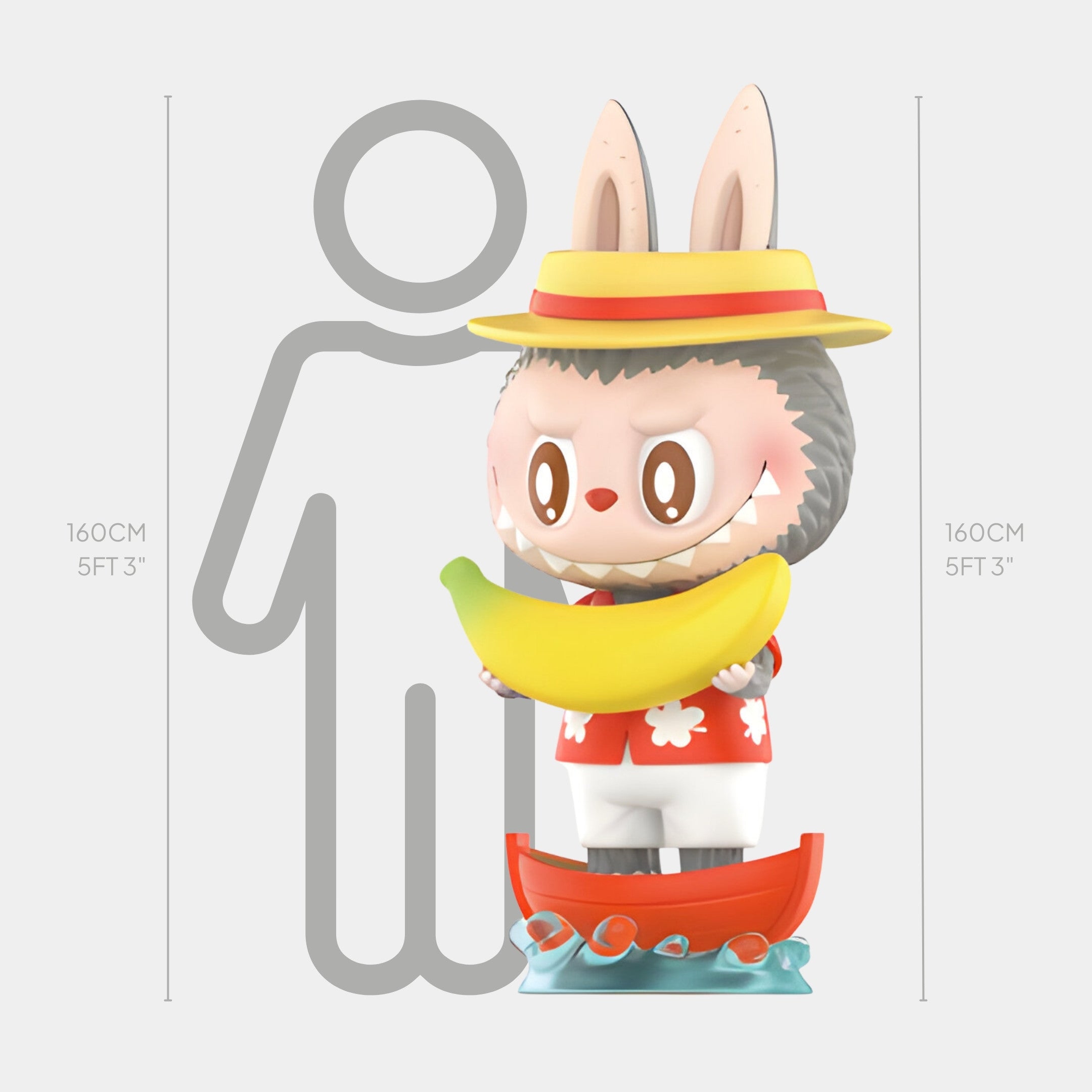 The Banana Fruit Labubu Sculpture - 160cm by Giant Sculptures is a pop-art figure of a bunny-eared animal in a yellow hat, red shirt, and white shorts, holding a large banana in a red boat and standing beside a person outline.