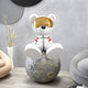 Giant Sculptures Nova White Astronaut Bear Moon Sculpture (80cm) showcases a bear in a gold visor and space suit seated on a gray, cratered moon. Complemented by a circular chair and minimalist decor in neutral tones, its ideal for space exploration ornament enthusiasts.