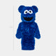 The Blue Fuzzy Bear Sculpture - 70cm by Giant Sculptures stands upright, featuring a fluffy blue design with large white eyes and a wide open mouth. A line to the left marks its height at 70 cm.