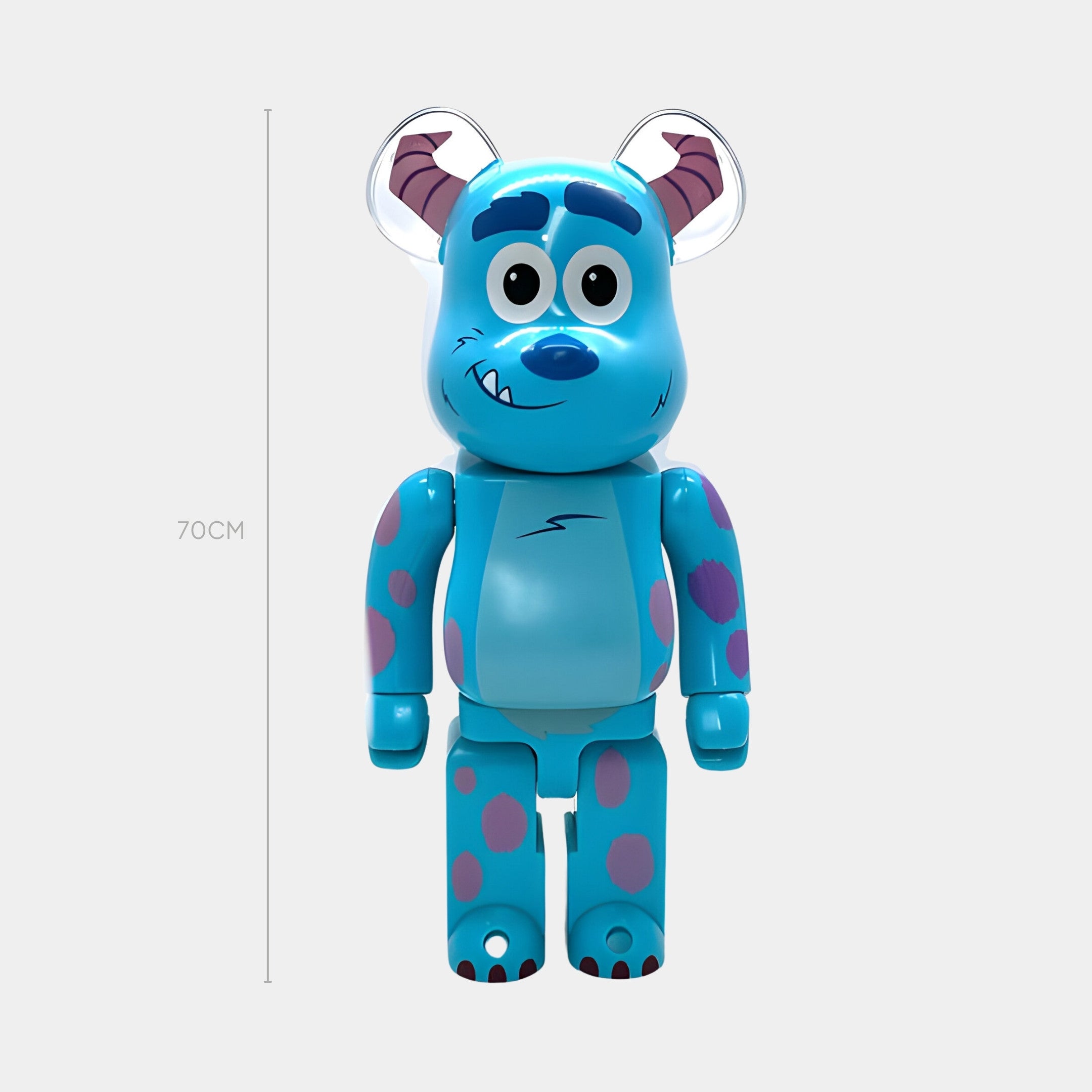The Blue Spotted Horn Bear Sculpture - 70cm by Giant Sculptures features a friendly face, purple spots, and whimsical horns. Crafted in resin and inspired by Monsters, Inc., its shown against a plain white background.