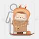 The Hidden Bread Bag Labubu Sculpture - 160cm by Giant Sculptures features a child in a brown bunny costume inside a YUMMY bakery-themed paper bag with a skull and chef hat, smiling sweetly with closed eyes.