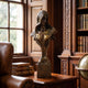 Classical Female Bust Bronze Bust - 75cm by Giant Sculptures, dark-patinated bronze with gilt floral detail, displayed on a wooden desk in a library setting.