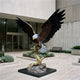 Monumental Traditional Bald Eagle Bronze Sculpture, 260cm, wings outstretched atop a gilded branch on a stone base, outside a building entrance.