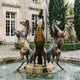 Monumental Classical Rearing Horses Bronze Fountain, 320cm, showing three bronze horses rearing around a central water jet in a courtyard pool.