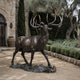 Monumental Contemporary Bugling Bull Elk Bronze Sculpture by Giant Sculptures, head raised mid-call with wide antlers, dark patina, on a stone courtyard.