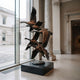 Monumental Traditional Flying Canada Geese Bronze Sculpture by Giant Sculptures, six geese ascending in vertical formation on a black plinth in a museum gallery.