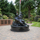 Life-Size Traditional Nurse and Soldiers Bronze Sculpture by Giant Sculptures on a circular granite plinth in a memorial garden with brick name plaques and flagpole.