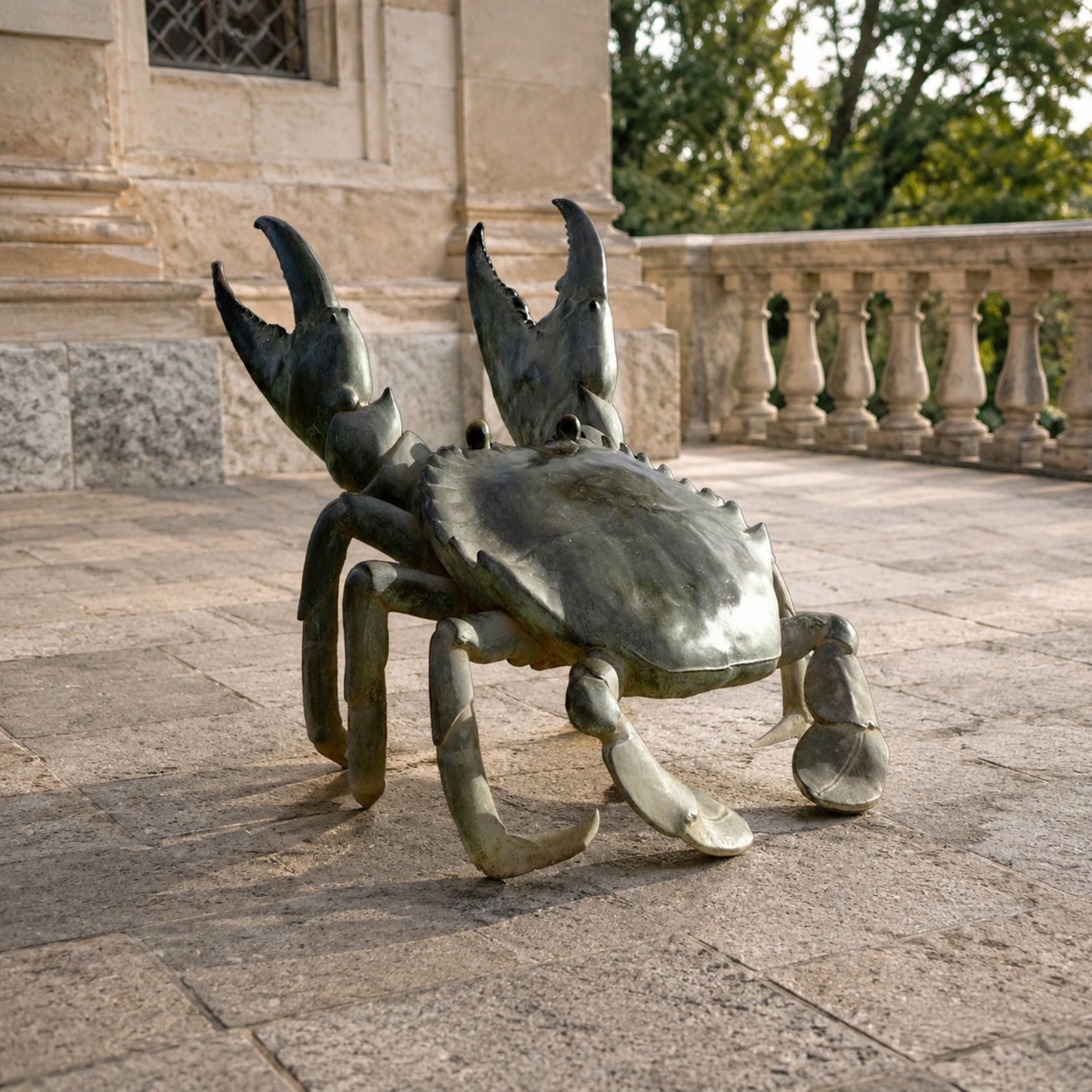 Large Contemporary Crab Bronze Sculpture by Giant Sculptures with raised claws and dark grey-green patina, displayed on a stone terrace beside a balustrade.