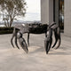 Large Contemporary Crab Bronze Sculpture by Giant Sculptures in dark patina, front view with claws spread, displayed on a stone terrace beside a building.