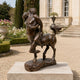Classical Centaur and Nude Female Figure Bronze Sculpture (Brown Patina), 100cm, on a stone base outdoors near a gravel path and garden estate.