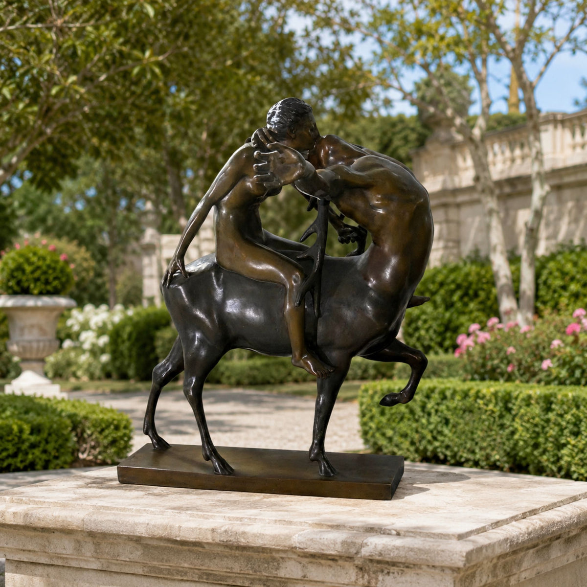 Classical Centaur and Nude Female Figure Bronze Sculpture, 100cm, dark patina finish, on a rectangular base, displayed outdoors on a stone plinth amid garden greenery.