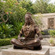 Large Traditional Shiva Meditation Bronze Sculpture, 120cm, seated in padmasana with gold-tone crown, earrings, and mala, shown outdoors on a stone plinth amid garden greenery.